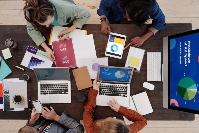 Marketing team reviewing an ad-spend breakdown for AI-assisted media buying